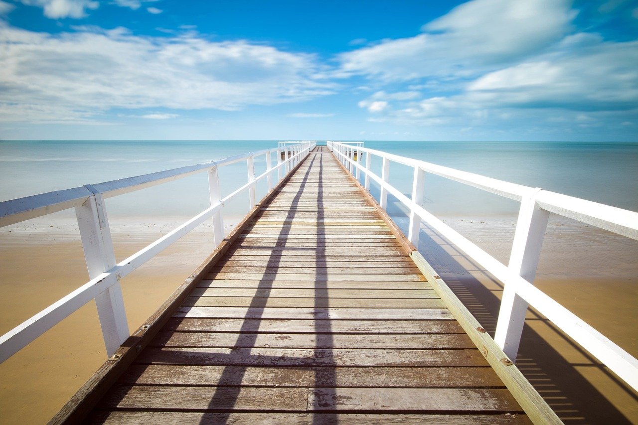 photo of a wooden deck in the open sea, this is what financial freedom feels like, one benefit of investing